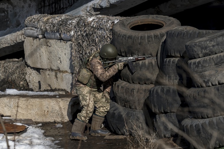 Ukrainian officer Dmitri Kebtz watches for separatist snipers