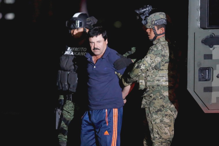 Image: Joaquin \"El Chapo\" Guzman is escorted by soldiers during a presentation in Mexico City, Jan. 8, 2016.