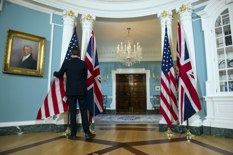 A U.S. flag is adjusted in the Treaty Room at the State Department