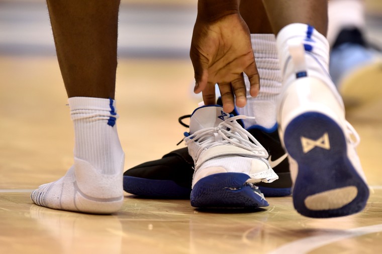 Image: Zion Williamson of the Duke Blue Devils picks up his broken sneaker during a game against the North Carolina Tar Heels in Durham on Feb. 20, 2019.