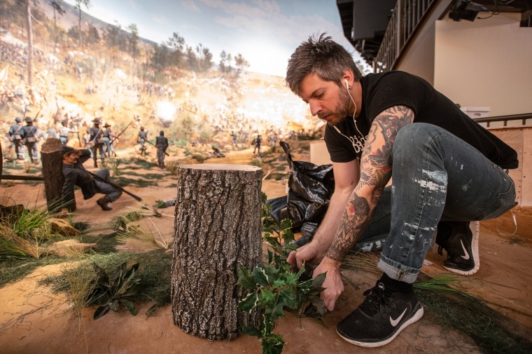 Image: A worker puts some final touches on the diorama that is part of the Atlanta Cyclorama display at the Atlanta History Center