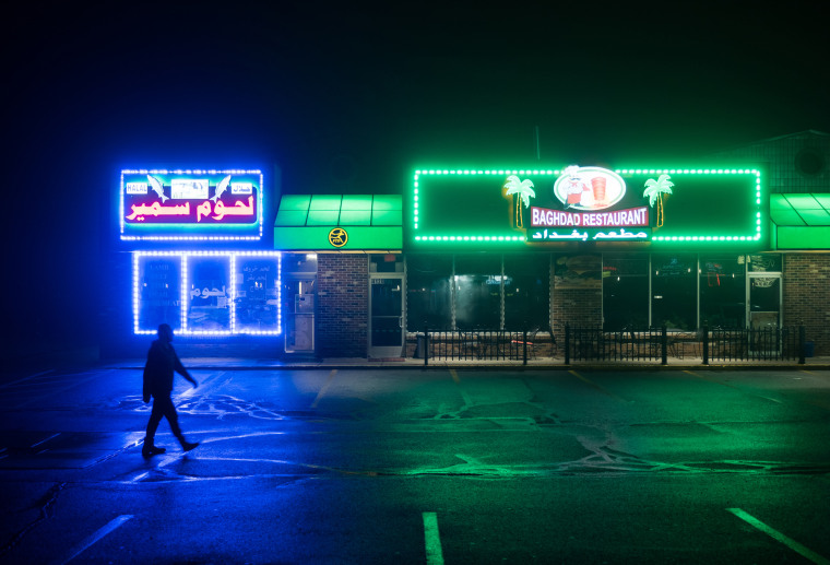 Image: A man walks past Iraqi storefronts in Sterling Heights, Michigan, on March 26, 2017.