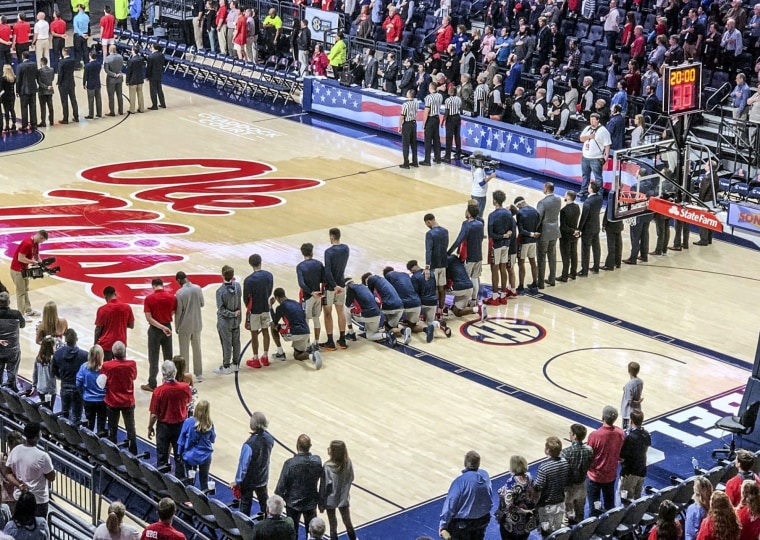 Image: Mississippi basketball players take a knee during the national anthem before a game against Georgia on Saturday.