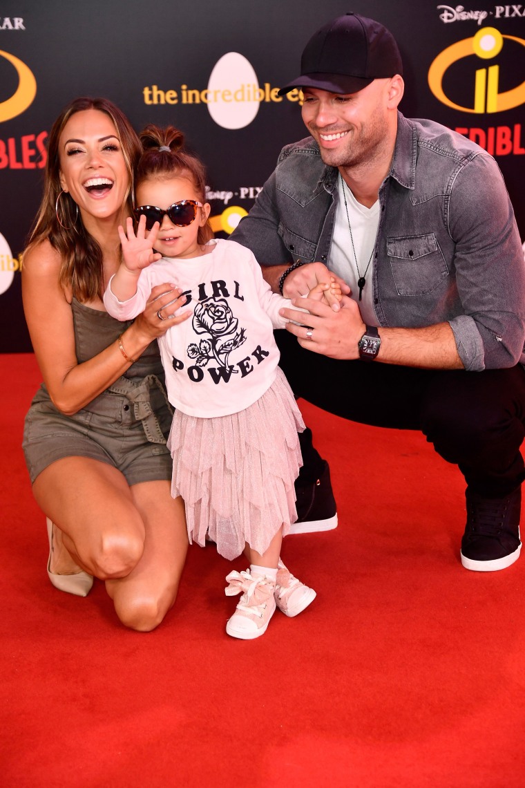 Jana Kramer and her husband, NFL player Mike Caussin, pose with their daughter, Jolie Rae, in June 2018.