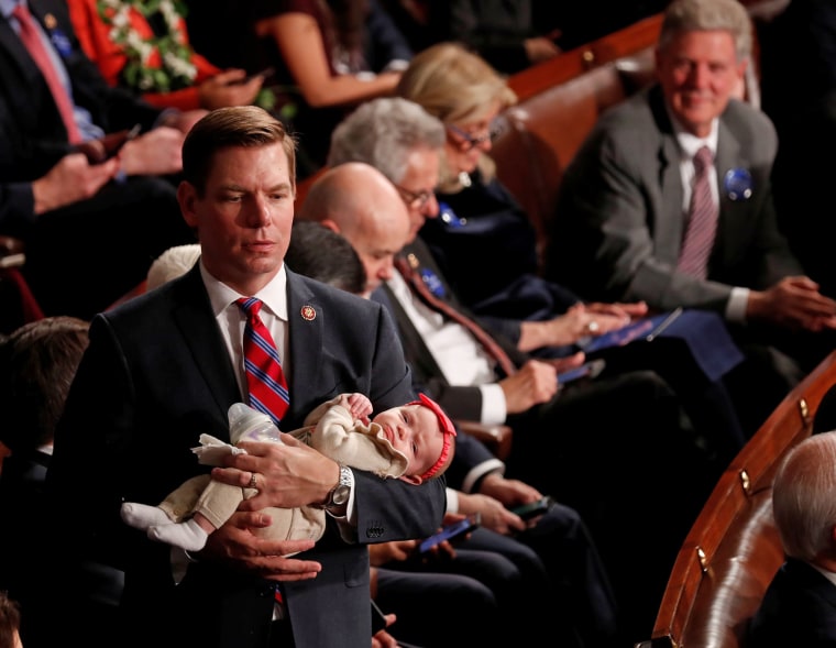 Image: U.S. Rep. Eric Swalwell (D-CA) holds his daughter Kathryn as the U.S. House of Representatives meets for the start of the 116th Congress in Washington