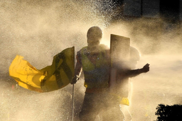 Image: "Yellow vest" protesters are showered by a water cannon in Bordeaux, France