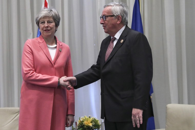 Image: British Prime Minister Theresa May shakes hands with European Commission President Jean-Claude Juncker 