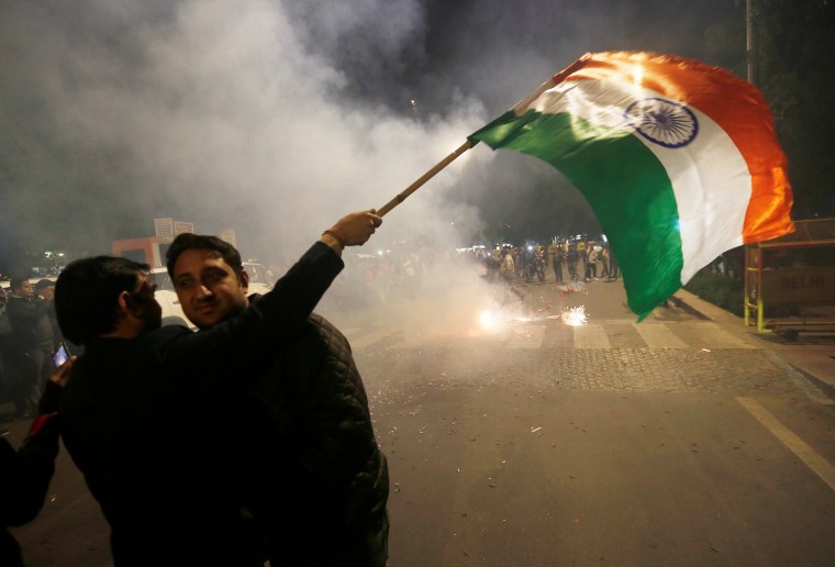 Image: A man holds an Indian flag in New Delhi
