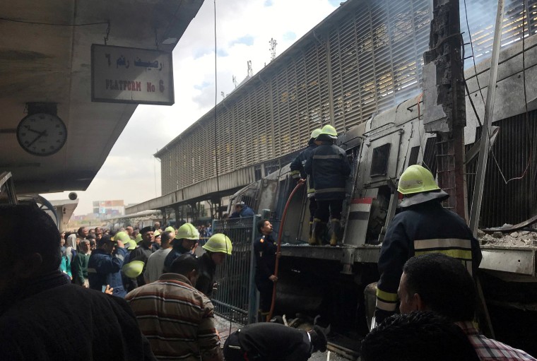 Image: Rescue workers attend a fire at the main train station in Cairo