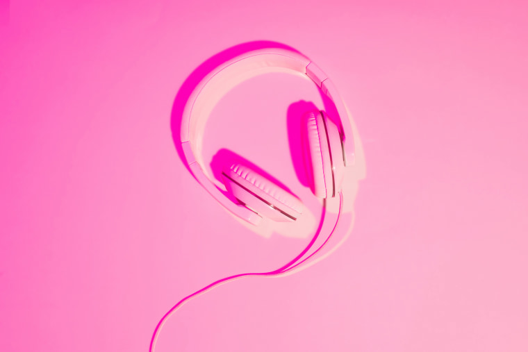 pink toned picture of headphones on pink background