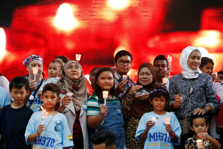 Image: Family members hold candles during the fifth annual remembrance event for the missing Malaysia Airlines flight MH370, in Kuala Lumpur