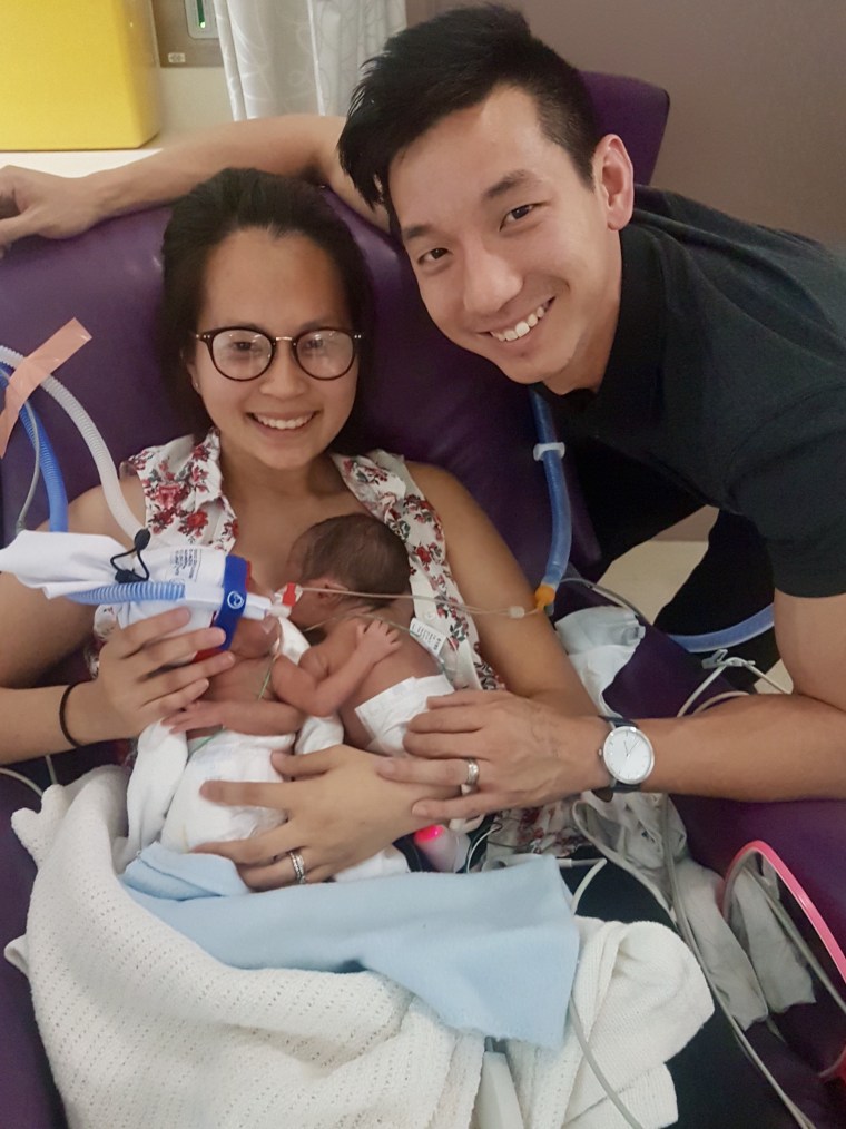 Ann Le and Jason Poon with their twin daughters.