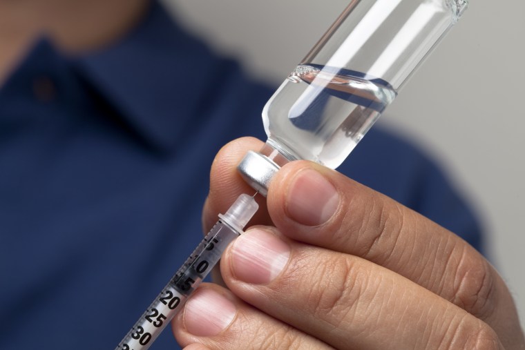 Image: Preparing syringe for insulin shot
