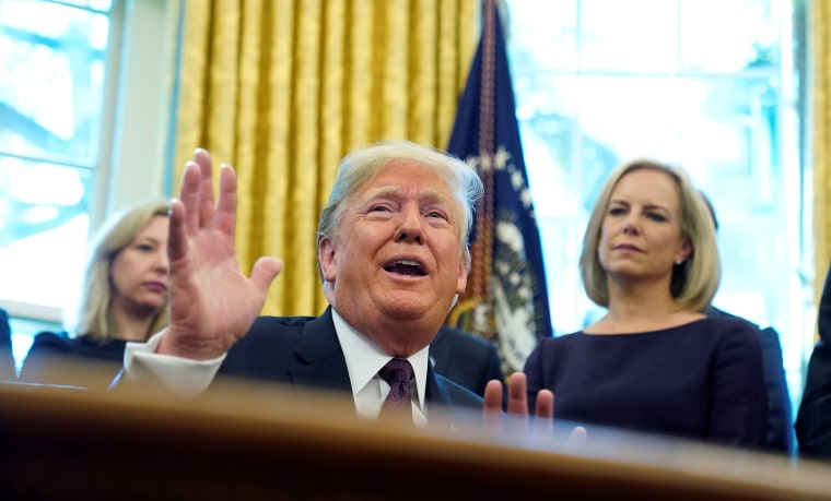 Image: President Trump talks to reporters at Cybersecurity and Infrastructure signing ceremony in Oval Office of White House in Washington