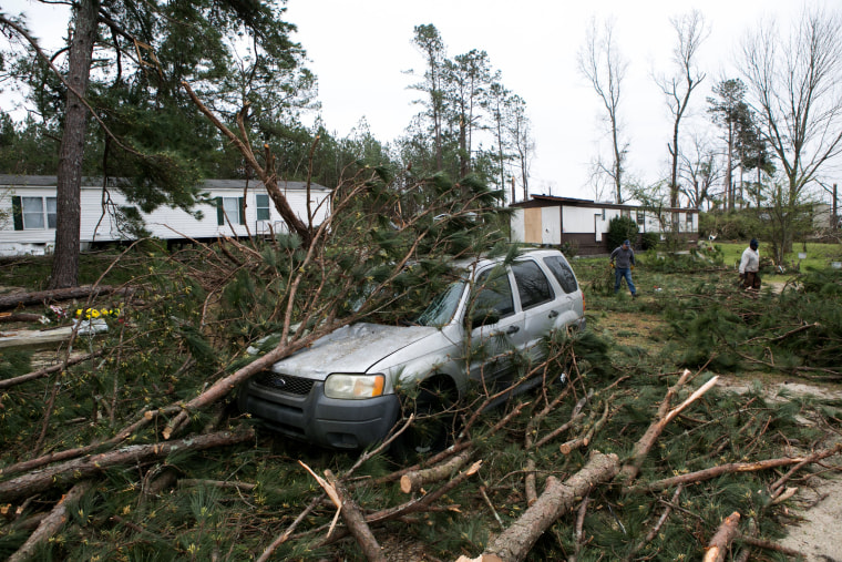 Image: Volunteers and residents clean up debris after a tornado in Beauregard, Alabama, on March 4, 2019.