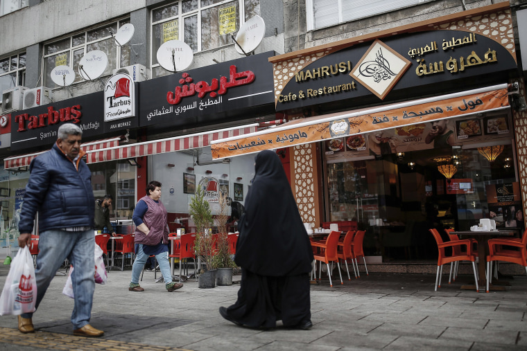 Image: People walk in the Fatih district in Istanbul