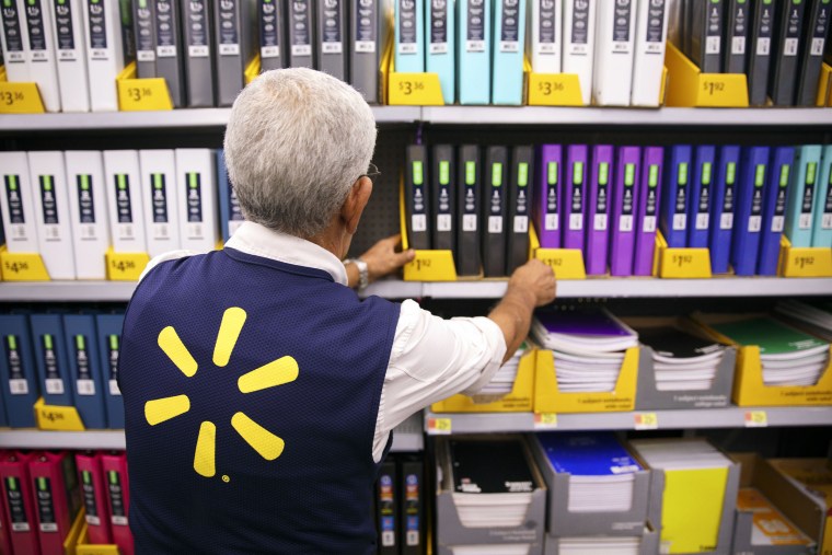 Image: An employee restocks shelves of school supplies at a Wal-Mart Stores Inc. location in Burbank, California