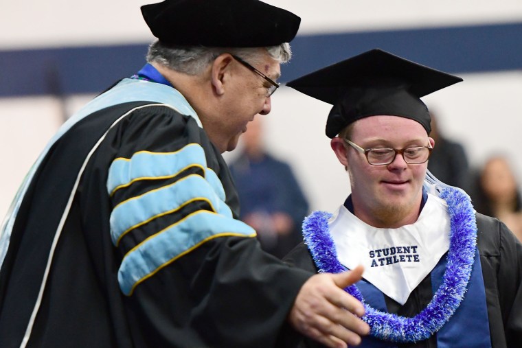 Cody Sullivan with Concordia University president on graduation day