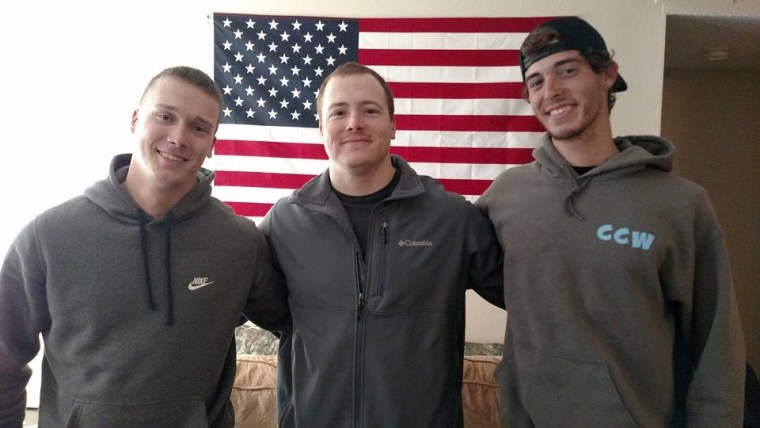 (Left to right) Brothers Jared, Joshua and Timmy (step-brothers to Jonathan and Stephen Full) pose in front of an American flag.