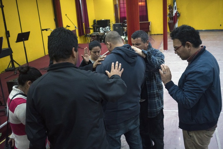 Image: Albert during a prayer ceremony at the Christian shelter Agape Misión in Tijuana.