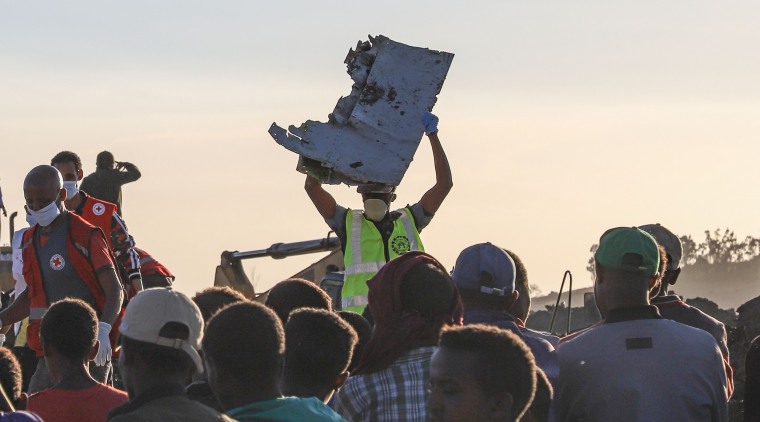 Image: Debris is removed from the crash site of the Ethiopian Airlines jet 