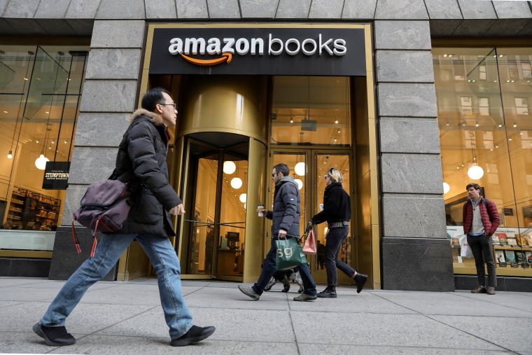 Image: People walk past an Amazon Books retail store in New York