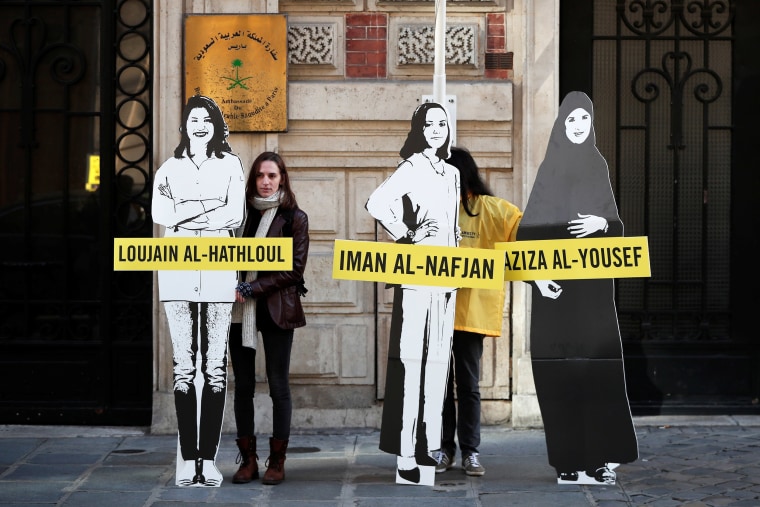Image: Demonstrators from Amnesty International protest outside the Saudi Arabian Embassy on International Women's day in Paris