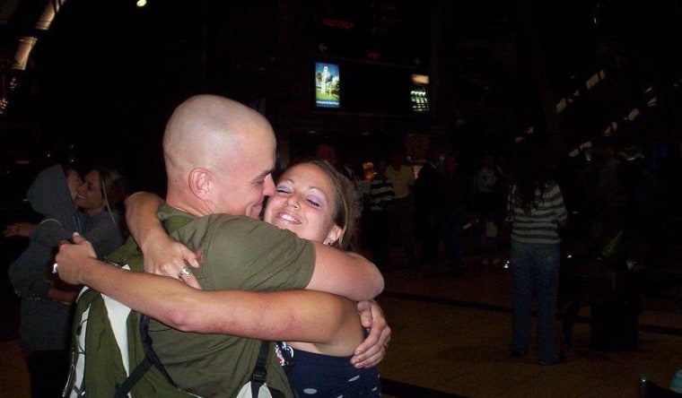 Amber Mosel,34, hugs her husband, retired Marine Sgt. Jason Mosel.