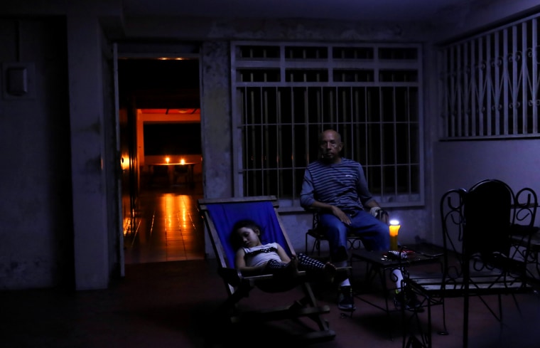 Image: People rest at their house during a blackout in Puerto Ordaz, Venezuela, on March 9, 2019.