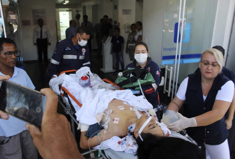 Image: A teenager who was injured during a shooting at the Raul Brasil State School is carried on a gurney into a hospital in Suzano, Brazil, on March 13, 2019.