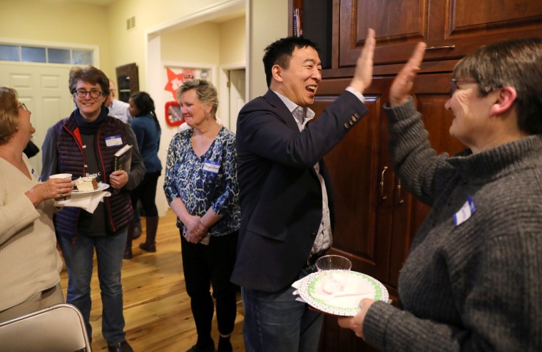 Image: Democratic presidential candidate Andrew Yang high fives with Charlotte Fairlie at an activist event in Iowa City, Iowa, on March 10, 2019.