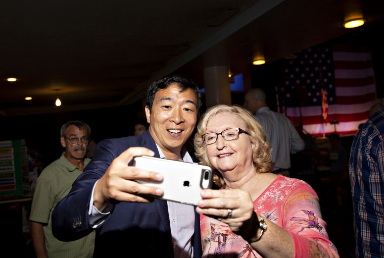 Image: Andrew Yang takes a selfie with an attendee at the Democratic Wing Ding event in Clear Lake, Iowa, on Aug. 10, 2018.