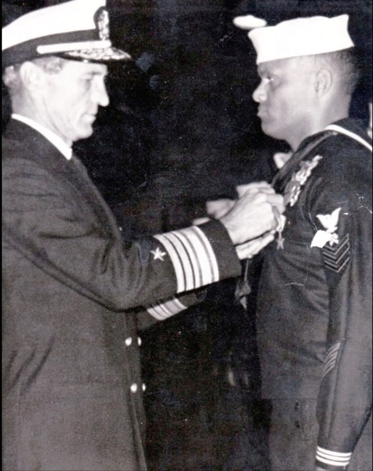 Bill Goines receives pin from senior U.S. NAVY officer as he joined the SEAL team.