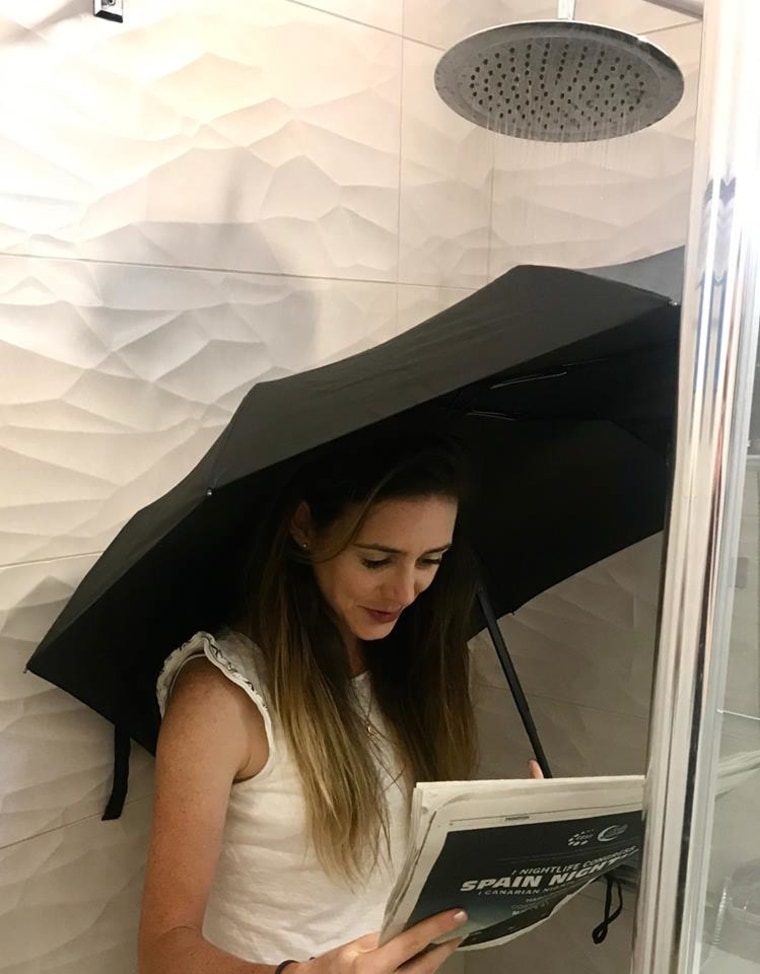 Katie Jackson testing the Repel Windproof Travel Umbrella in the shower