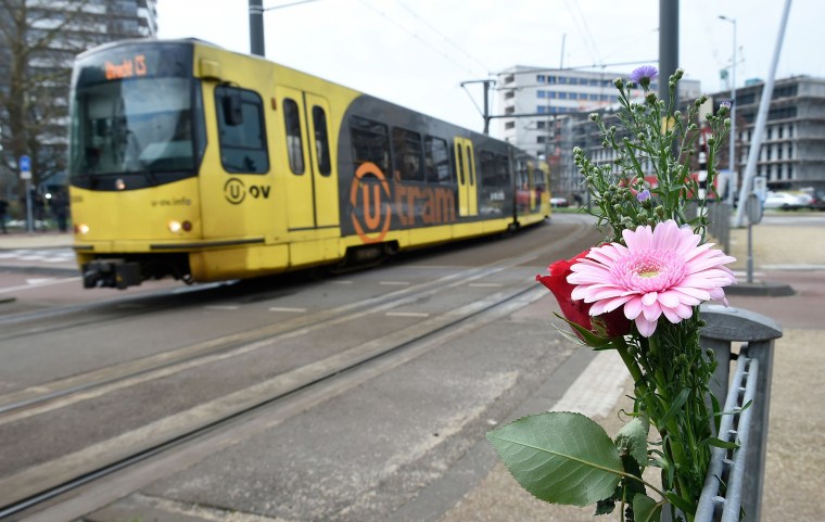 Image: Flowers have been set up in tribute to victims at the site of a shooting in a tram, at 24 October square in Utrecht,