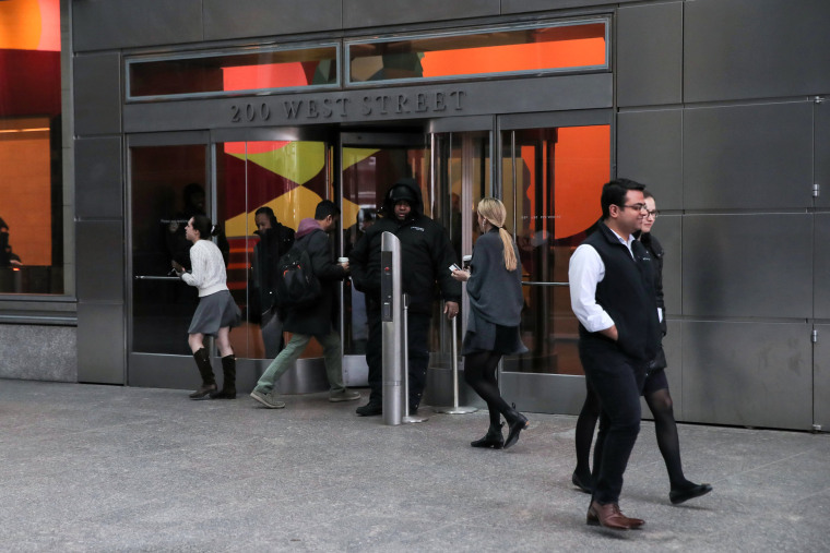 Image: People enter and exit 200 West Street the Goldman Sachs building in New York on March 6, 2019.