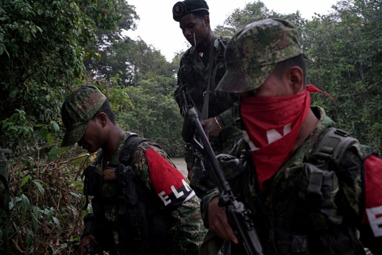 Image: Rebels of Colombia's National Liberation Army (ELN) patrol the river in the northwestern jungles of Colombia on Aug. 30, 2017.