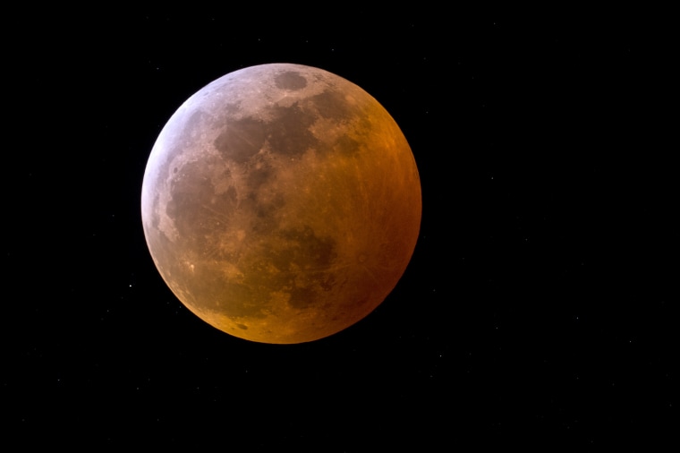 A total lunar eclipse accompanied the first in a trio of back-to-back supermoons in 2019.