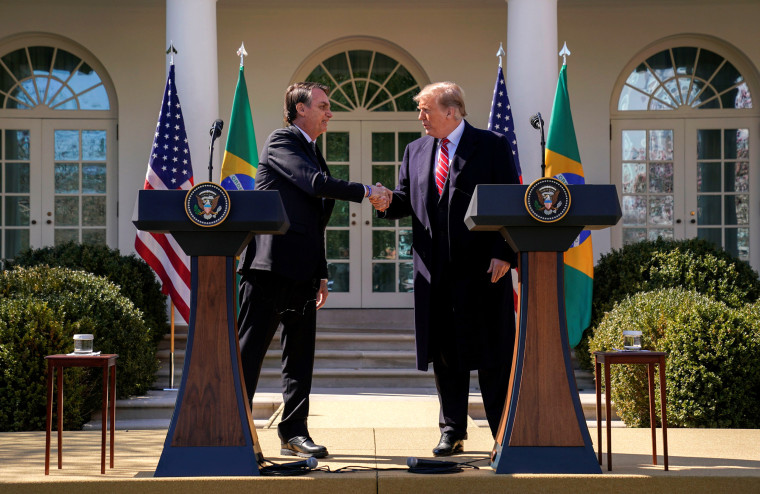 Image: Brazil's President Jair Bolsonaro and President Donald Trump shake hands during a news conference in the Rose Garden of the White House on March 19, 2019.