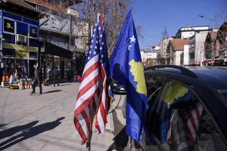 Image: U.S. and Kosovo flags displayed for sale in the street in the town of Mitrovica