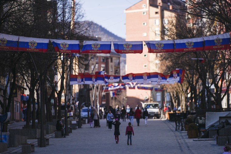 Image: Kosovan Serbs walk under Russian and Serbian flags at the main square in the north of Mitrovica
