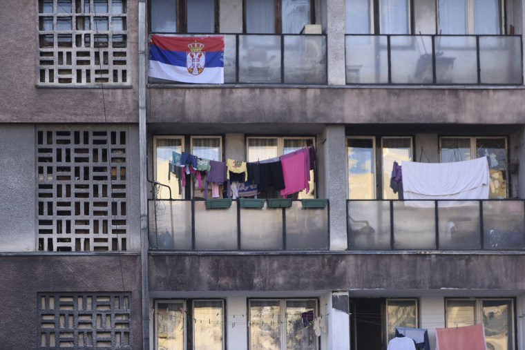 Image: A Serbian national flag is displayed in an apartment  in the north of Mitrovica