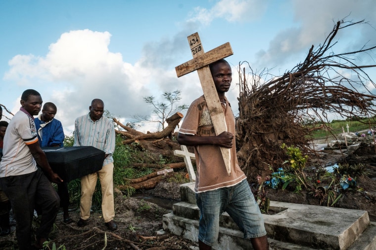 Image: People carry the coffin of Tomas Joaquim Chimukme during his funeral, after his home collapsed following a strong cyclone that hit Beira, Mozambique