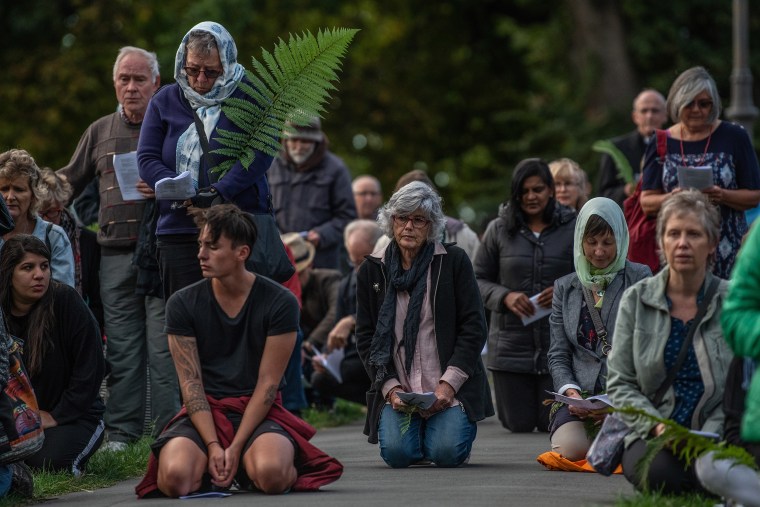 Image: People kneel for prayer during a vigil to remember victims of the Christchurch mosque attacks,