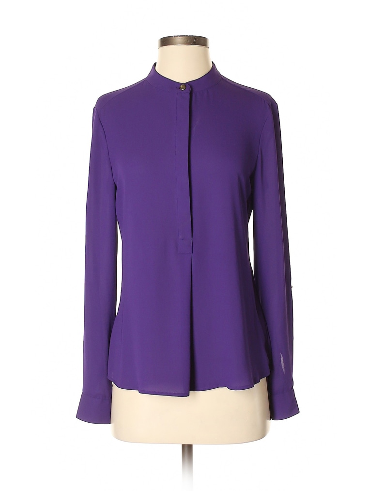 Dylan's purple blouse features a crew neckline and long sleeves.