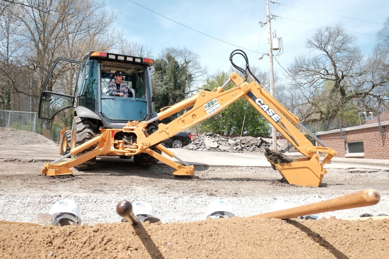 Brad Paisley operates a backhoe, while breaking ground for "The Store."