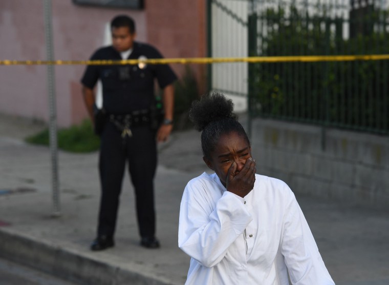 Image: A woman outside The Marathon clothing store owned by Grammy-nominated rapper Nipsey Hussle where he was fatally shot along with 2 other wounded
