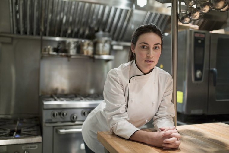 Image: A female chef in restaurant kitchen