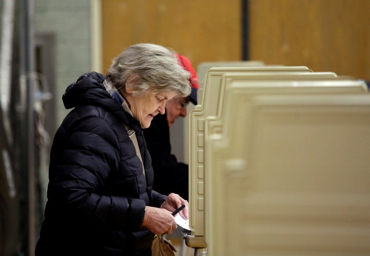 Image: Voters fill out their ballot at a polling place during a runoff election for mayoral candidates Toni Preckwinkle and Lori Lightfoot in Chicago