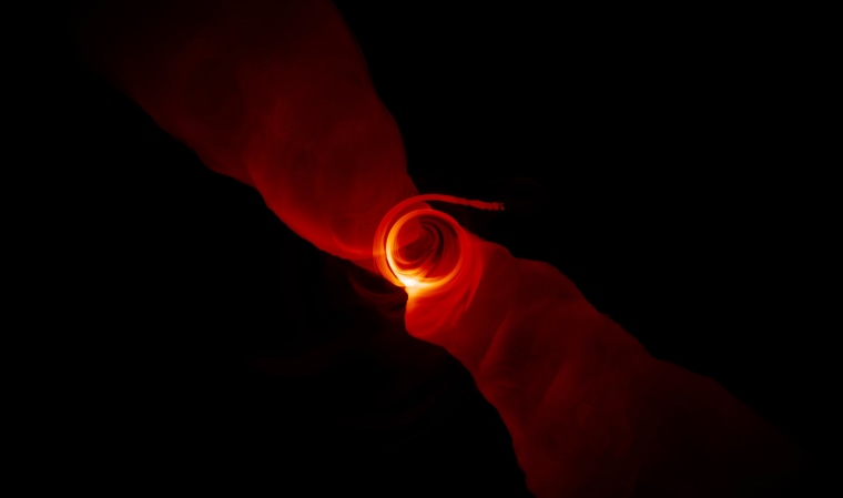 A simulated image shows the turbulent plasma in the extreme environment around a supermassive black hole.